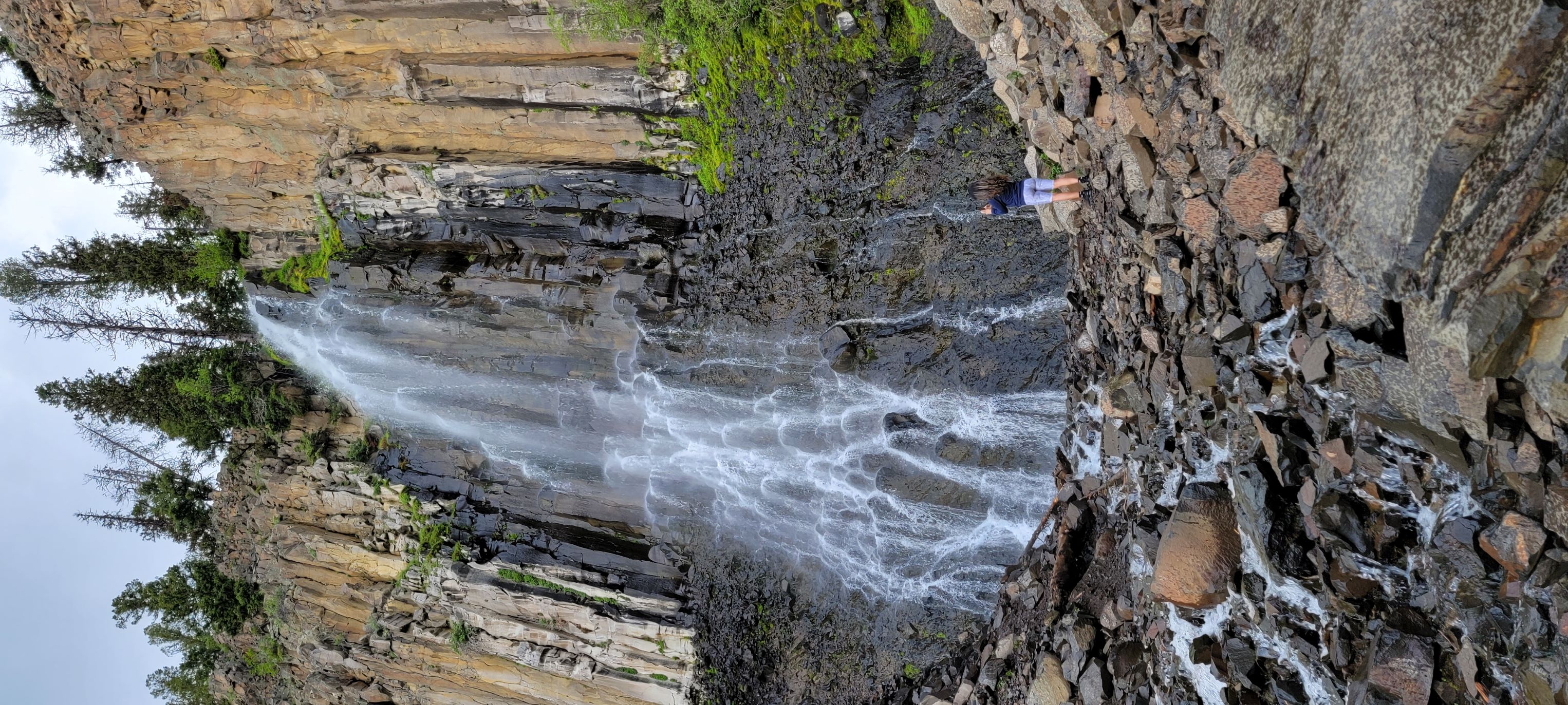 4'11" Woman at Palisade Falls to show how tall is this Montana waterfall. 4'11" Woman at Palisade Falls to show how tall is this Montana waterfall.